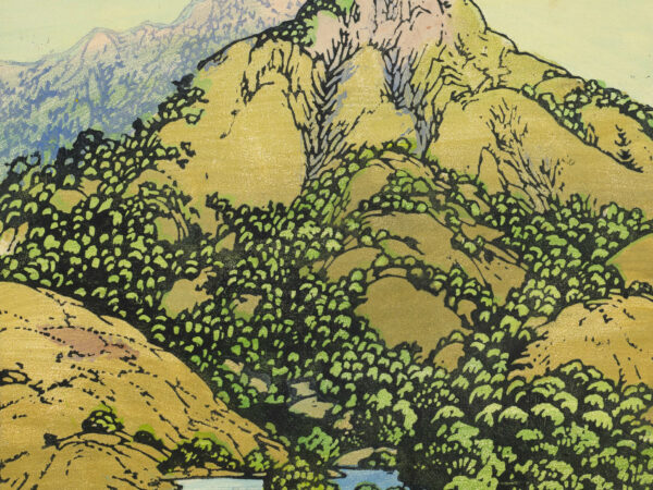 Landscape with trees and lake in the foreground and mountains in the background