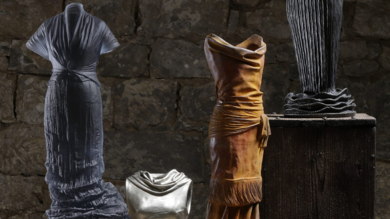 Photo of three human forms wearing dresses that are made of glass