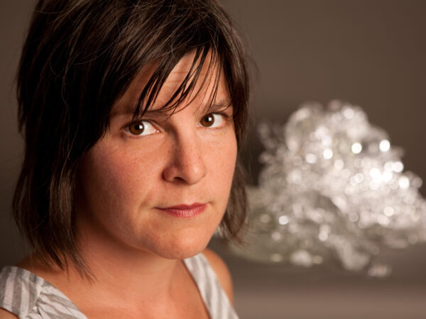 Woman with glass sculpture at right